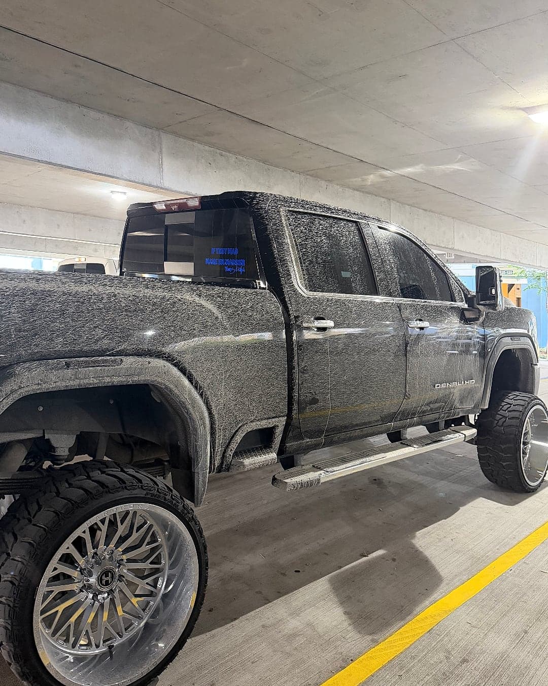 Lifted black GMC Sierra Denali HD on polished forged wheels, detailed by MJ's Mobile Detailing — before