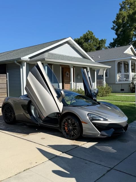 Silver McLaren with its doors raised after a full interior and exterior detail by MJ's Mobile Detailing