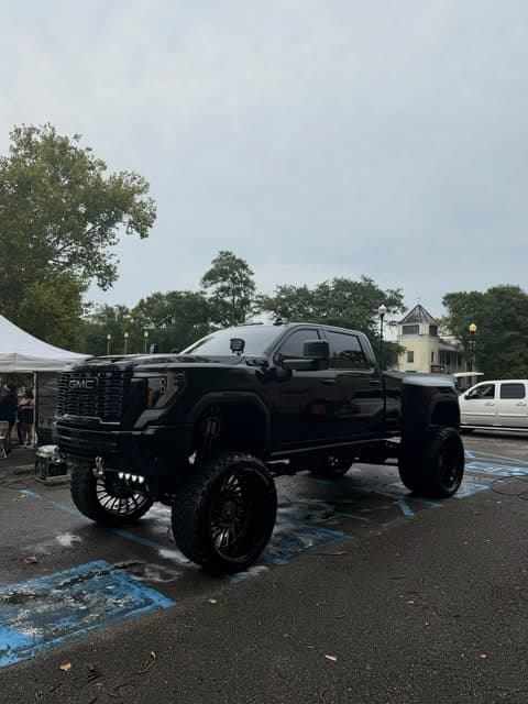 Lifted black truck covered in foam during an exterior hand wash by MJ's Mobile Detailing